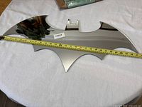 Batman logo mirror front with tape showing width