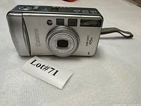 Front view showing lens, branding and flash