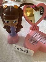 Front view of Diva Starz figurine and Hello Kitty heart mirror opened