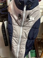 Front view of navy and grey quilted dog coat with zipper and D-rings