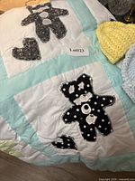 Quilt corner showing bear and heart appliqués, pastel sashing