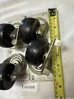 Top view showing four swivel casters, tape for scale