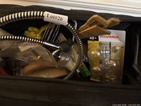 Close-up of shower components, bulbs and tools inside bag