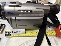 Left side view of Panasonic camcorder showing zoom and model markings