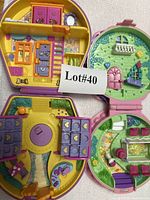 Both Polly Pocket stable compacts open showing interiors