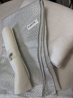 Stack of white and silver batting with rolled batting on top