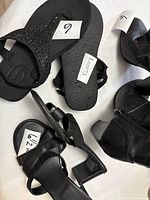 All three pairs of footwear displayed with size tags