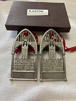 Front view of both pewter cathedral ornaments with box