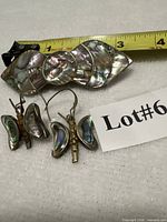 front view barrette and earrings beside tape measure