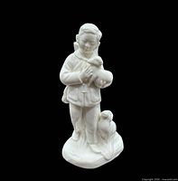 Front view of porcelain boy holding lamb with second lamb at base