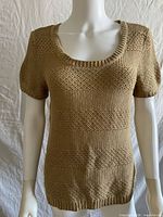 Front view of beige knit short-sleeve sweater on mannequin