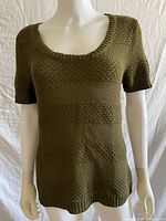 Front view of olive knit short-sleeve sweater on mannequin