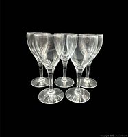 Front view of all five clear hand-blown wine glasses