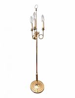 Full view of brass floor lamp with three lights and round base