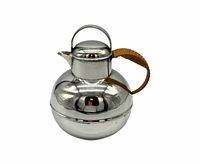 Full view of silverplate jug with lid and wicker handle