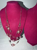Front view of triple-strand necklace showing pink stones and silver-tone beads