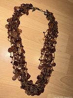 Necklace coiled to show multi strands and beads
