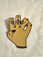 Front view of enamel hand pin