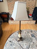 Full view of lamp with shade on tabletop