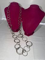 Necklace displayed on busts showing overall length and link style