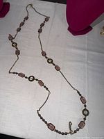 Full length view of necklace laid out showing bead pattern and lobster clasp