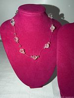 Full view of clear faceted bead choker necklace on display bust