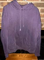 Front view of purple hoodie on hanger