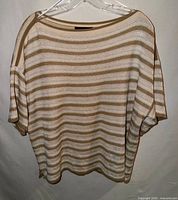Front view of striped sweater on hanger