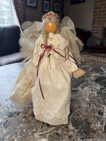 Full view of angel doll standing on table