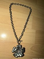 Full view of choker necklace laid flat showing chain, toggle clasp, and pendant