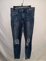Front view of jeans showing overall style, distressing and ripped knees