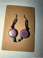 Front view showing both earrings on card highlighting bead colors, cord, and hooks