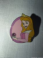 Front view of Disney Princess Aurora enamel pin with rhinestone detail