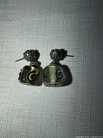Front view of both earrings showing green cubes and silver caps