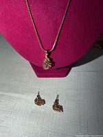 Necklace on display bust, earrings below