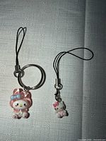 My Melody and Hello Kitty phone charms showing figures and straps