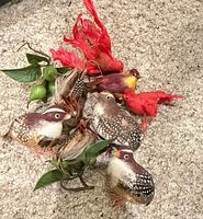 Group of artificial birds with red feather, brown speckled birds and faux leaves