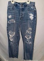 Full front view of ripped PacSun jeans showing overall condition, distressing, and raw hems.