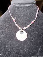 Full view of necklace on bust showing pendant, bead arrangement and double cords