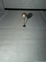 Full view standing of pearl hat pin