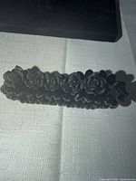 Close-up of black resin roses side by side