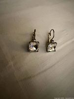 Front view of both earrings showing rectangular crystals and leverbacks