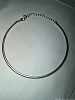 Full view of silver collar choker laid flat