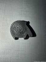 Front view of pewter horse head showing shape and engraved details