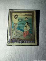 Front view of brooch showing stamp image and size context