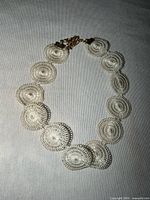 Full view of lace disc choker laid flat