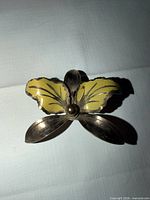 Front view showing yellow enamel wings and gold-tone body