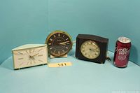 All three Westclox clocks side by side with soda can for scale