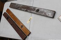 Three wooden spirit levels on table