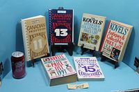 Six price guide books displayed upright and flat on blue background